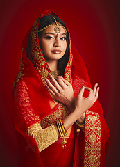 Image showing Fashion, hand sign and portrait of Indian woman with veil in traditional clothes, jewellery and sari. Religion culture, beauty and female person on red background with accessory, cosmetics and makeup