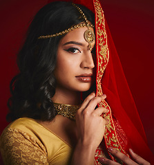 Image showing Fashion, beauty and portrait of Indian woman with veil in traditional clothes, jewellery and sari. Religion, culture and eyes of female person on red background with accessory, cosmetics and makeup