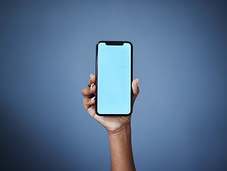 Image showing Phone, mockup and woman hand in studio with space for plan, menu or information, contact or space on dark background. Blue screen, smartphone and person show text, product placement or social media