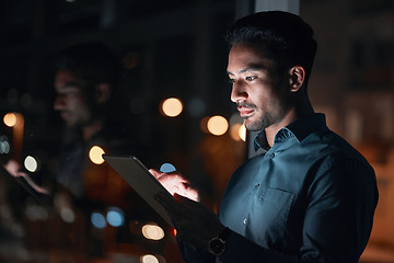 Image showing Night, work or man reading on tablet for research, project or planning a proposal in office building, startup or professional employee. Overtime, working or search on internet or online communication