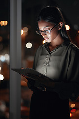 Image showing Night, work or woman reading on tablet for research, project or planning a proposal in office building, startup or professional employee. Overtime, working or search on internet, online communication