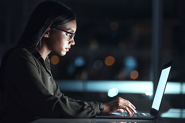 Image showing Laptop, research and business woman in coding, software development and programming for night cybersecurity. Computer, typing and screen reflection, focus and data analysis of programmer or IT person