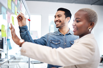 Image showing Happy creative people, writing and glass board for schedule planning, strategy or brainstorming at office. Man and woman in teamwork for startup project plan, sticky note or tasks at the workplace