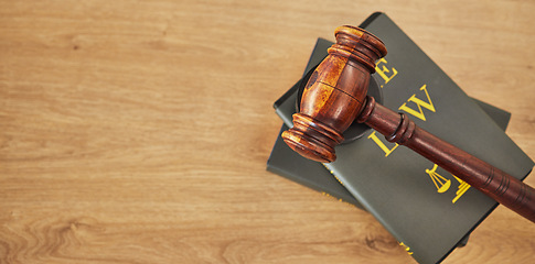 Image showing Gavel, law and books on wooden table, space or mockup for judge, justice or lawyer in courtroom. Background, hammer and research knowledge for legal study, constitution and truth, litigation or trial