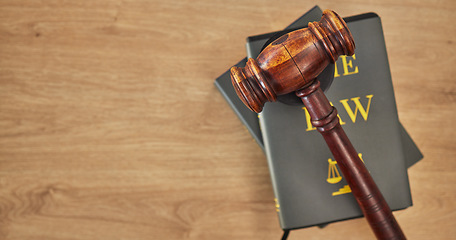 Image showing Background, law books and gavel on table at mockup space of judge, justice or lawyer in courtroom. Overhead, hammer and research knowledge of legal system, constitution and truth, litigation or trial