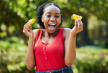 Image showing Happy black woman, orange slice and natural vitamin C for nutrition or citrus diet in nature outdoors. Portrait of African female person with organic fruit, food or fiber for healthy wellness in park