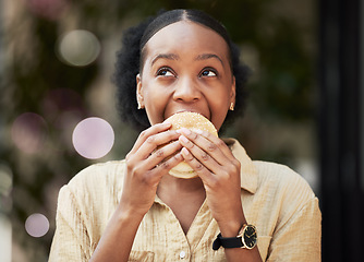 Image showing Thinking, fast food and black woman biting a burger in an outdoor restaurant as a lunch meal craving deal. Breakfast, sandwich and young female person or customer enjoying a tasty unhealthy snack