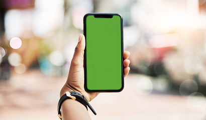 Image showing Phone, green screen and person hands in city for social media, advertising and website ui or ux design mockup. Mobile app, technology and people with smartphone space for outdoor or urban travel