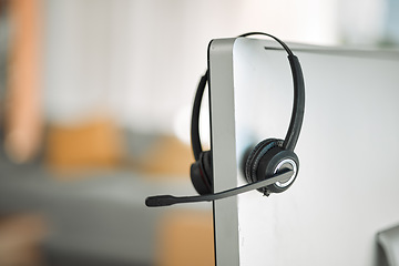 Image showing Headset, computer and customer service in a call center for support, consulting or telemarketing after hours. Contact, crm and communication equipment in an empty office for help or assistance