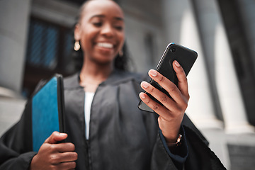 Image showing Judge at court, hand and phone to contact a client, communication or legal services and advice on mobile app online. Smile, black woman and smartphone for research, information or consulting law