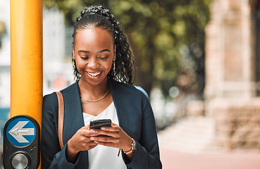 Image showing Happy black woman, phone and city in travel, social media or communication in Cape Town. African female person with smile for chatting, texting or networking on mobile smartphone app by traffic light