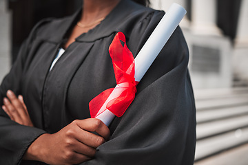 Image showing University, graduation and certificate with a student arms crossed on campus, confident in her achievement. Diploma, education and college with an african graduate standing outdoor at a ceremony