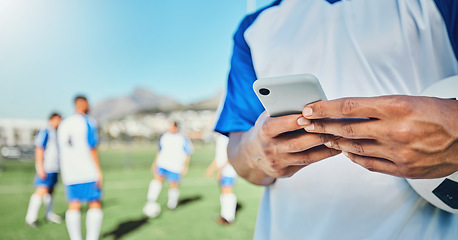 Image showing Football, field, phone and man hands for competition, training or fitness news, social media chat and blog. Soccer player or person typing on mobile app for sports information, health or goal check