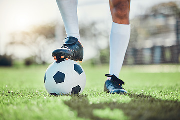 Image showing Legs, sports or man with a soccer ball on a field for exercise, fitness and training for a competition outdoors. Football club, ready or boots of player in a game event or match in stadium on grass