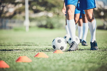 Image showing Feet, soccer player and ball with training cone on a field for sports game and fitness. Legs or shoes of male soccer or athlete person outdoor for agility, performance or workout on a grass pitch