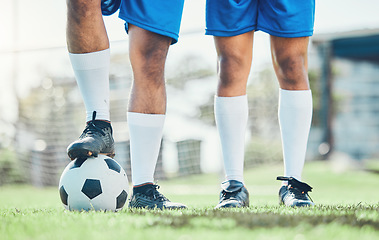 Image showing Legs, soccer and ball with a team ready for kickoff on a sports field during a competitive game closeup. Football, fitness and teamwork on grass with players standing on grass to start of a match