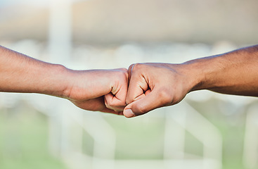 Image showing Soccer, fist bump and hands for teamwork, support and sports for training at stadium outdoor. Collaboration, together and football players with motivation for exercise target, workout goal or success