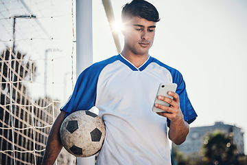 Image showing Soccer ball, phone and man on field for competition, training or fitness news, social media chat and blog. Football player or person search on mobile app for sports information, health or goals check