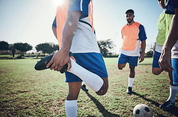 Image showing Football player, stretching legs and men training on a field for sports game and fitness. Male soccer team or athlete group outdoor for challenge, workout or warm up exercise on a grass pitch