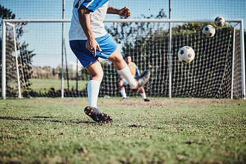 Image showing Sports, training and football player score a goal for challenge at a game or match at tournament. Fitness, exercise and back of soccer athlete kicking a ball at practice on outdoor field at stadium.