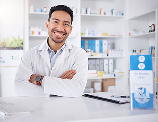 Image showing Asian man, portrait and pharmacist with arms crossed in pharmacy, drugstore or shop. Face, confidence or medical professional, happy doctor or worker with a pharmaceutical job for healthcare in Japan