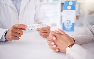 Image showing Closeup, client or pharmacist with a product, hands or discussion with container with healthcare. Zoom, human or medical professional with a box, wellness or treatment in a drug store or prescription