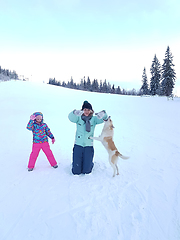 Image showing Happy young mother with daughter in the winter park with dog.