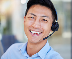 Image showing Portrait, smile and an asian man in a call center for customer service, support or lead generation. Face, contact and headset with a happy young male consultant working in an office for assistance