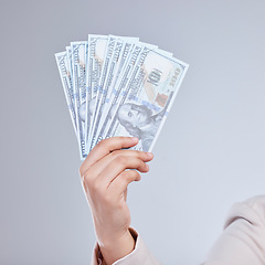 Image showing Money, hand and woman in studio with savings, success or cashback, reward and bonus on grey background. Cash, investment and female winner show casino, poker or gambling award with financial freedom