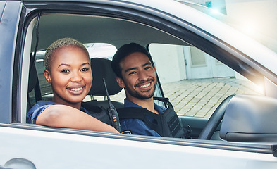 Image showing Police, driving together and portrait in car, smile and happy partnership to stop crime with teamwork in city. Black woman, man and patrol street in metro for justice, law and government surveillance