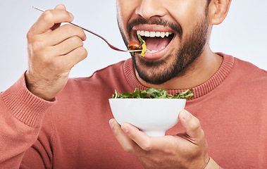 Image showing Health studio, man and mouth eating salad, vegetables or green food product for weight loss, healthy lifestyle or nutrition. Closeup nutritionist, lettuce bowl and hungry person on white background