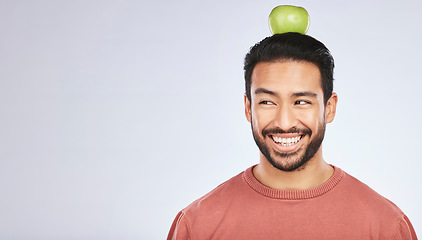 Image showing Head balance, thinking or happy man with apple decision for weight loss diet, healthy lifestyle change or nutrition choice. Studio food, fruit mockup space or hungry person ideas on white background