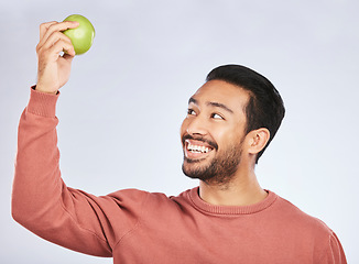 Image showing Studio smile, happy and man with apple product for weight loss diet, healthy lifestyle change or body nutrition goals. Eating wellness food, nutritionist fruit and hungry person on white background