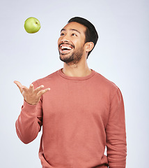 Image showing Health studio, throw and happy man with apple product for weight loss diet, healthy food or nutrition meal, vitamin or fiber. Wellness, nutritionist fruit or hungry person excited on white background
