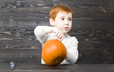 Image showing little boy cut a pumpkin