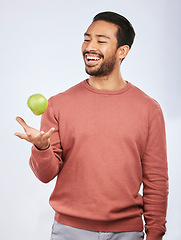 Image showing Studio, fruit throw and happy man with apple product for self care diet, clean healthy gut or nutrition meal, vitamin or detox. Happiness, nutritionist food or hungry person smile on white background