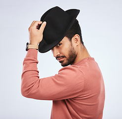 Image showing Retro, fashion and portrait of man with a hat for vintage style or hipster clothing trend in white background. Studio, Indian model and serious face with cool, confidence or person acting as a spy