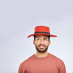 Image showing Fashion, hat and mockup with a confused man in studio isolated on a gray background in doubt about his style. Question, mistake and frown with a young asian male model in trendy red headwear