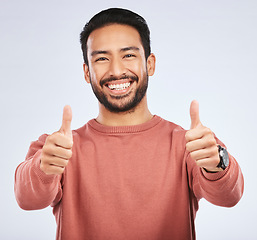 Image showing Thumbs up, portrait and man support for success in studio, white background and winning news. Happy asian male model, thumb emoji and like of feedback, good review and vote yes in agreement of winner