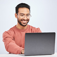 Image showing Laptop, IT and man with glasses in studio, white background and programming digital code. Happy asian male model, software developer and computer engineer typing on technology for coding website data