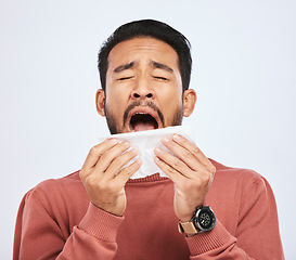 Image showing Allergy, sneeze and asian man is sick with tissue in studio with grey background with cold or sinus. Virus, allergies and male person with toilet paper for flu or problem with nose or congestion.