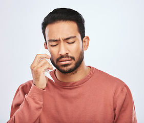 Image showing Depression, crying and sad asian man in studio with tissue, criss or broken heart on grey background. Stress, mistake and face of male person with tears for anxiety, trauma or crisis, regret or fail