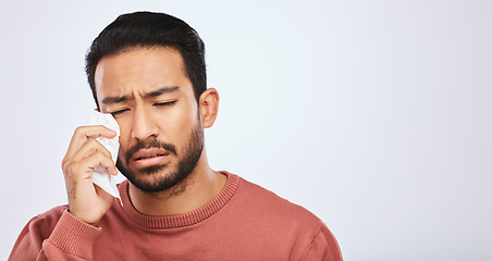 Image showing Crying, depression and sad asian man in studio with tissue, crisis or broken heart on grey background. Stress, mistake and face of male with tears for anxiety, trauma or bad news, fail or mourning