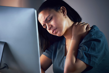 Image showing Business woman, neck pain and night in burnout, stress or fatigue by computer at office. Frustrated, overworked and tired female person with sore shoulder, muscle or tension working late at workplace