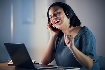 Image showing Happy woman, headphones and listening to music at night for online audio streaming on office desk. Female person or employee working late and enjoying sound track or songs on headset at the workplace