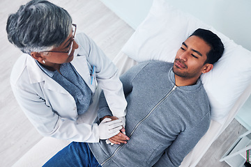 Image showing Sick, above and doctor holding hands with a man in a hospital for support, consulting and care. Healthcare, bed and a mature medical person with comfort for a patient with stomach cancer in clinic