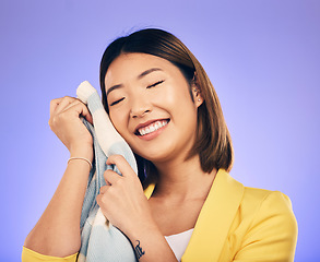 Image showing Woman, soft jersey and smile in studio with fashion choice, quality fabric and happy by purple background. Young Japanese designer, material and excited with product, touch skin and pride in career