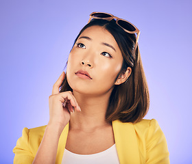 Image showing Thinking, glasses and wondering with asian girl or idea in purple background in studio with decision. Choice, contemplation and woman with creative thought or face and person or option for solution.