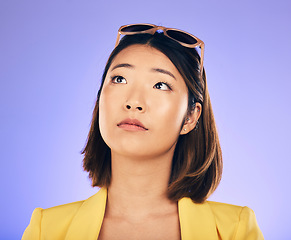 Image showing Thinking, woman and face with sunglasses for fashion, idea or think of summer holiday on purple studio background. Choice, decision and Asian model with glasses on head with cool gen z style