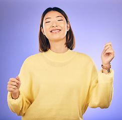 Image showing Happy asian woman, dancing and music in freedom or casual fashion against a purple studio background. Female person or model smile enjoying energy, event or party in happiness for clothing style